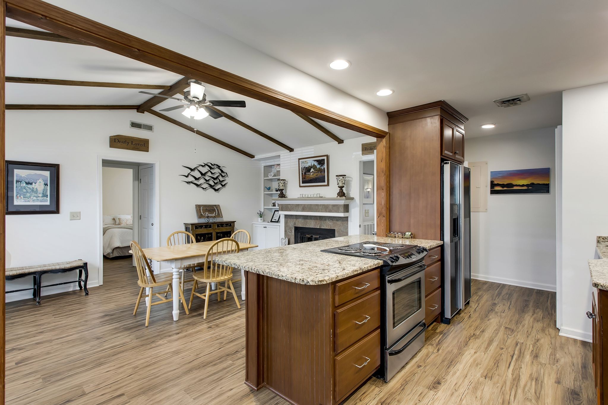 1122 General George Patton Road Nashville, TN 37221 - Photo 12 of 32 a kitchen with a stove a refrigerator and a dining table with wooden floor