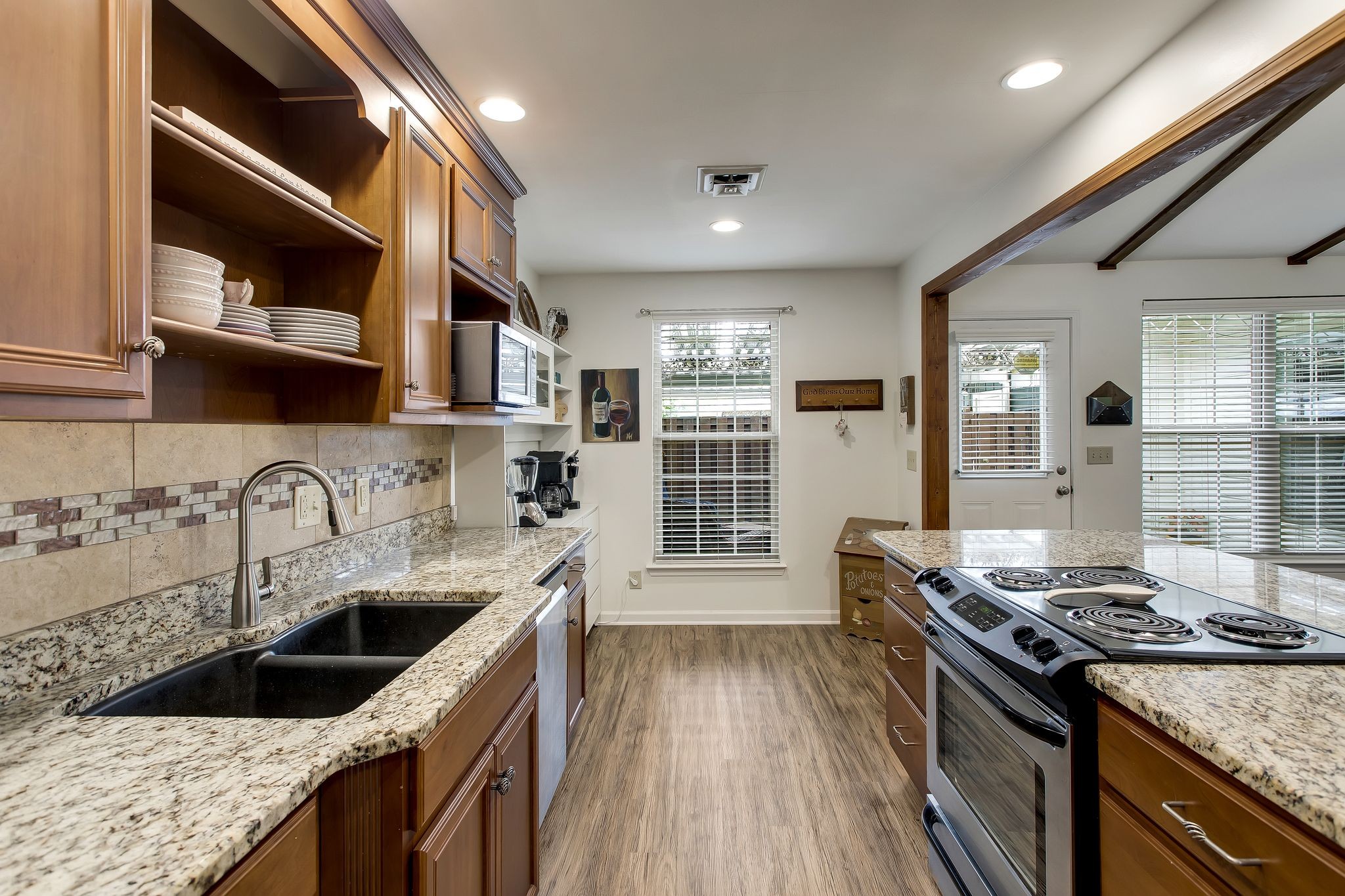 1122 General George Patton Road Nashville, TN 37221 - Photo 13 of 32 a kitchen with granite countertop a sink stove and refrigerator