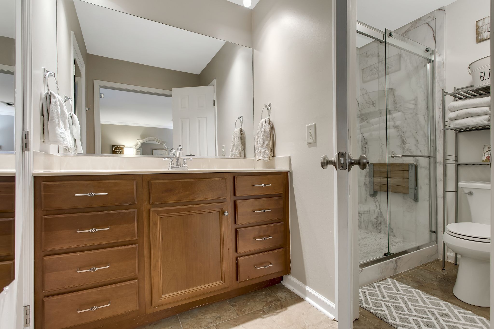1122 General George Patton Road Nashville, TN 37221 - Photo 20 of 32 a bathroom with a shower a sink and a mirror