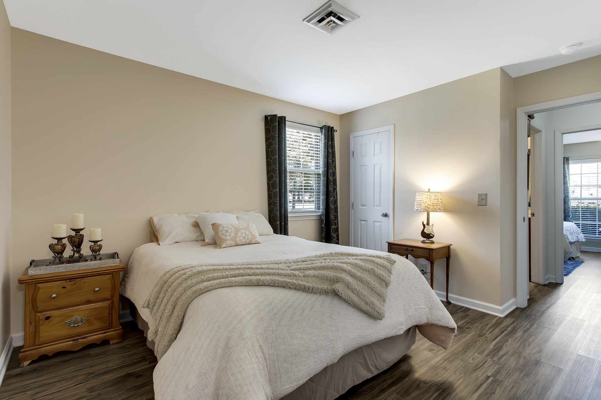 1122 General George Patton Road Nashville, TN 37221 - Photo 22 of 32 a bedroom with a bed and wooden floor