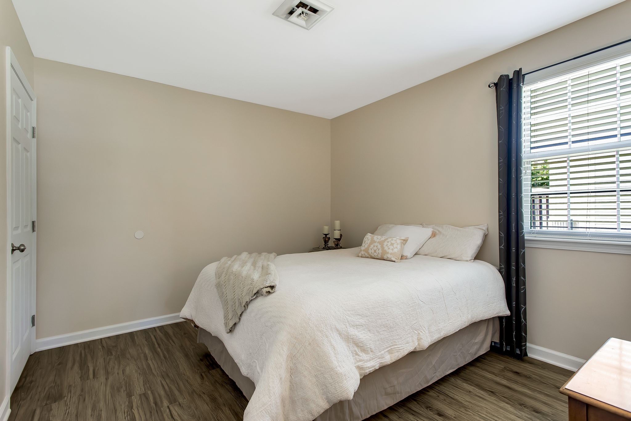 1122 General George Patton Road Nashville, TN 37221 - Photo 23 of 32 a bedroom with a bed and wooden floor