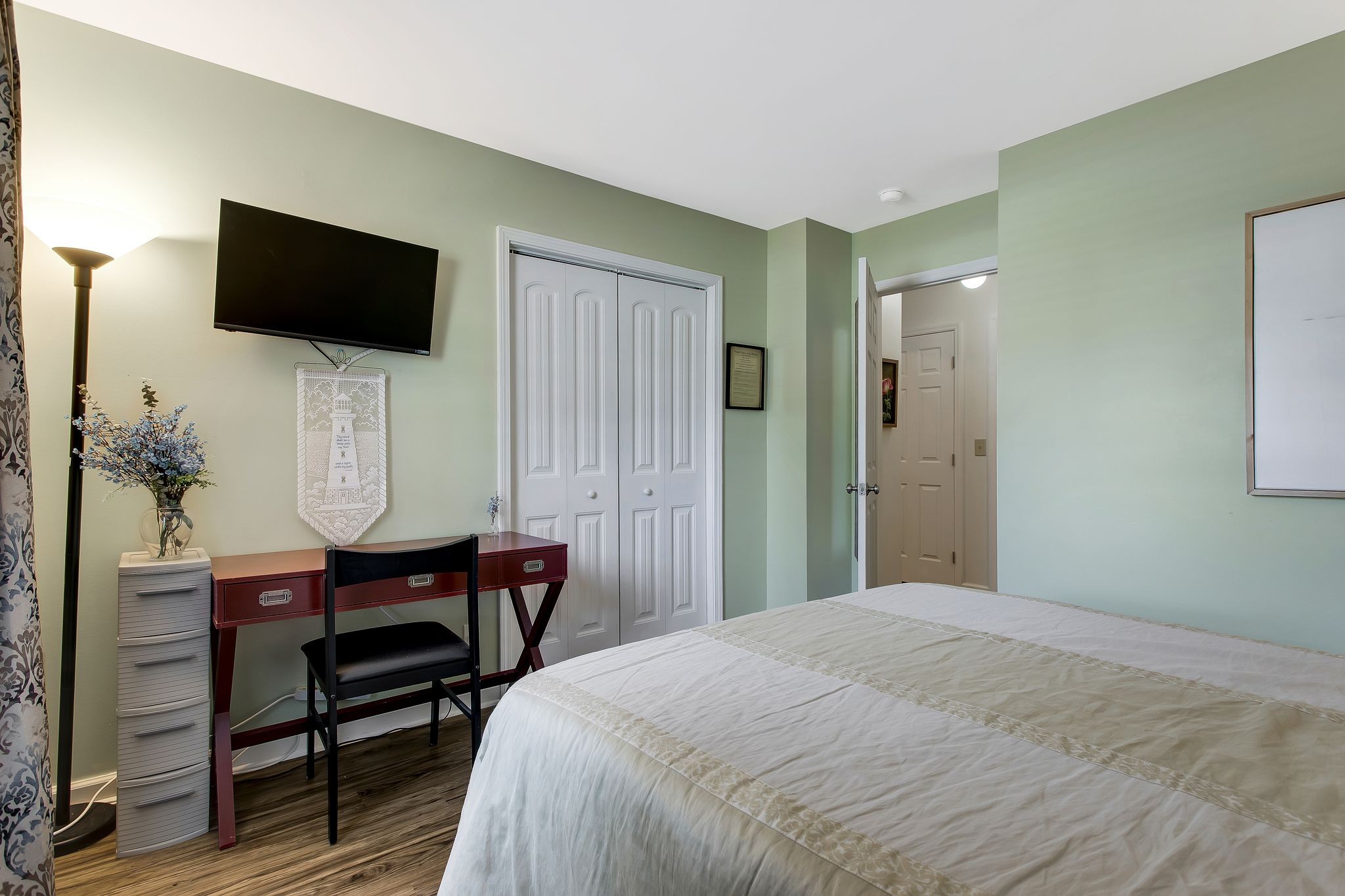 1122 General George Patton Road Nashville, TN 37221 - Photo 25 of 32 a bedroom with a bed table chair and a flat screen tv