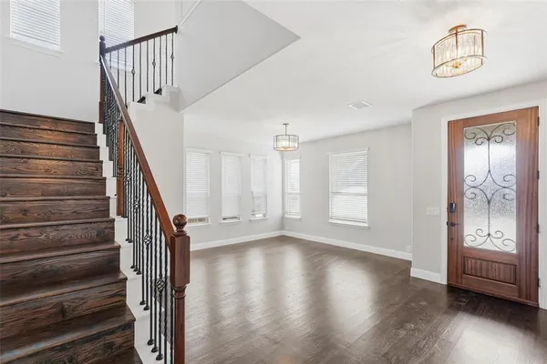 a view of an entryway with wooden floor