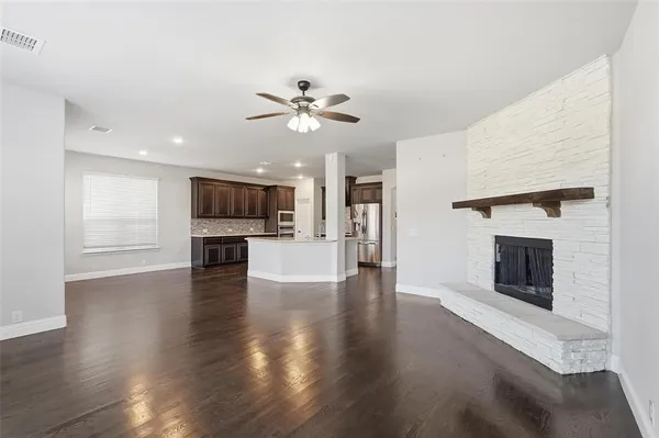 a view of a kitchen with an empty space and a fireplace