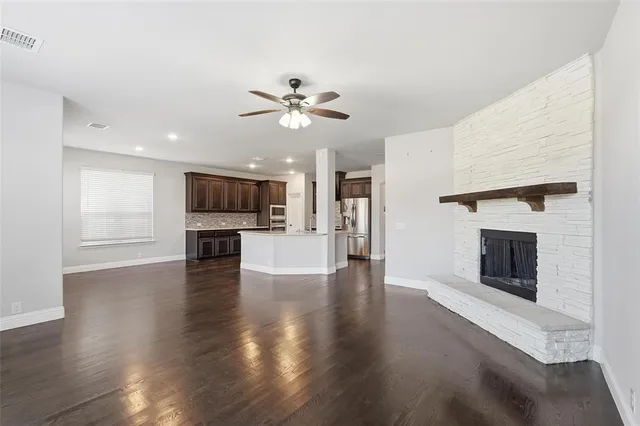 a view of a kitchen with an empty space and a fireplace