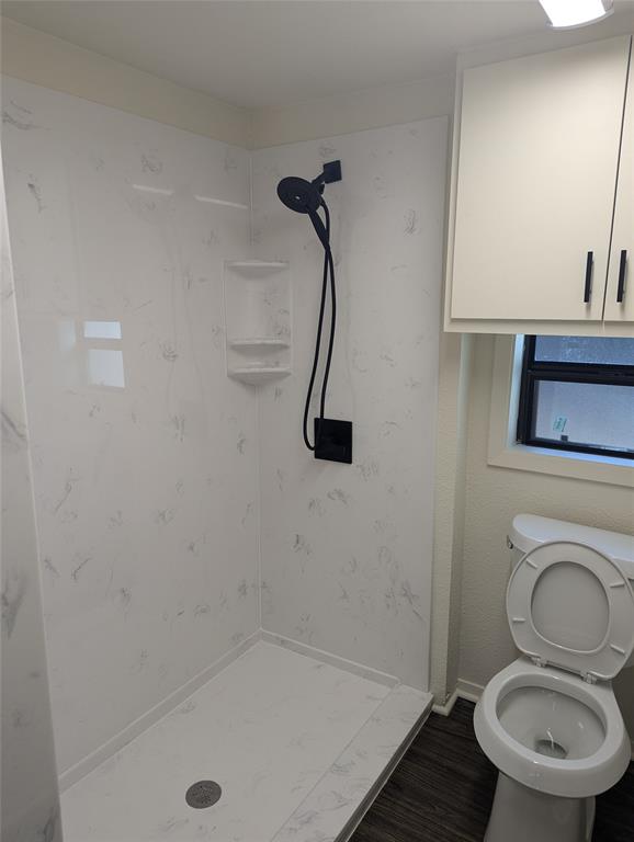 502 East Baker Street Hamilton, TX 76531 - Photo 16 of 37 a bathroom with a sink a toilet and a shower