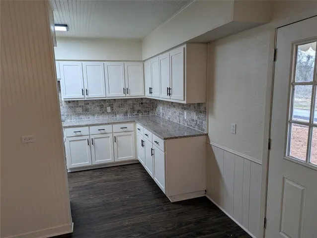 a view of a kitchen with a sink cabinets and wooden floor