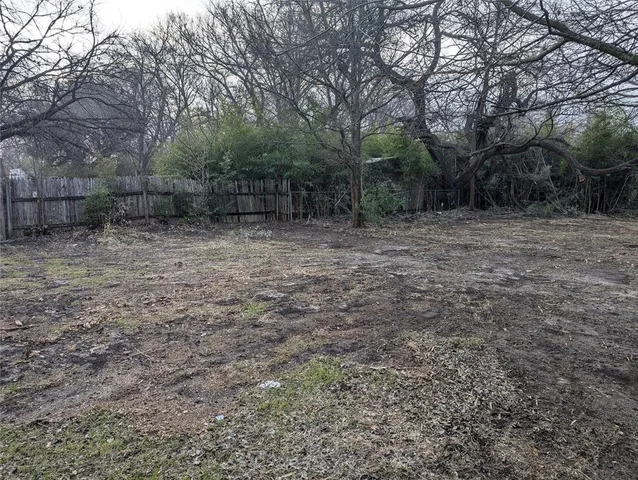 a view of a yard with trees