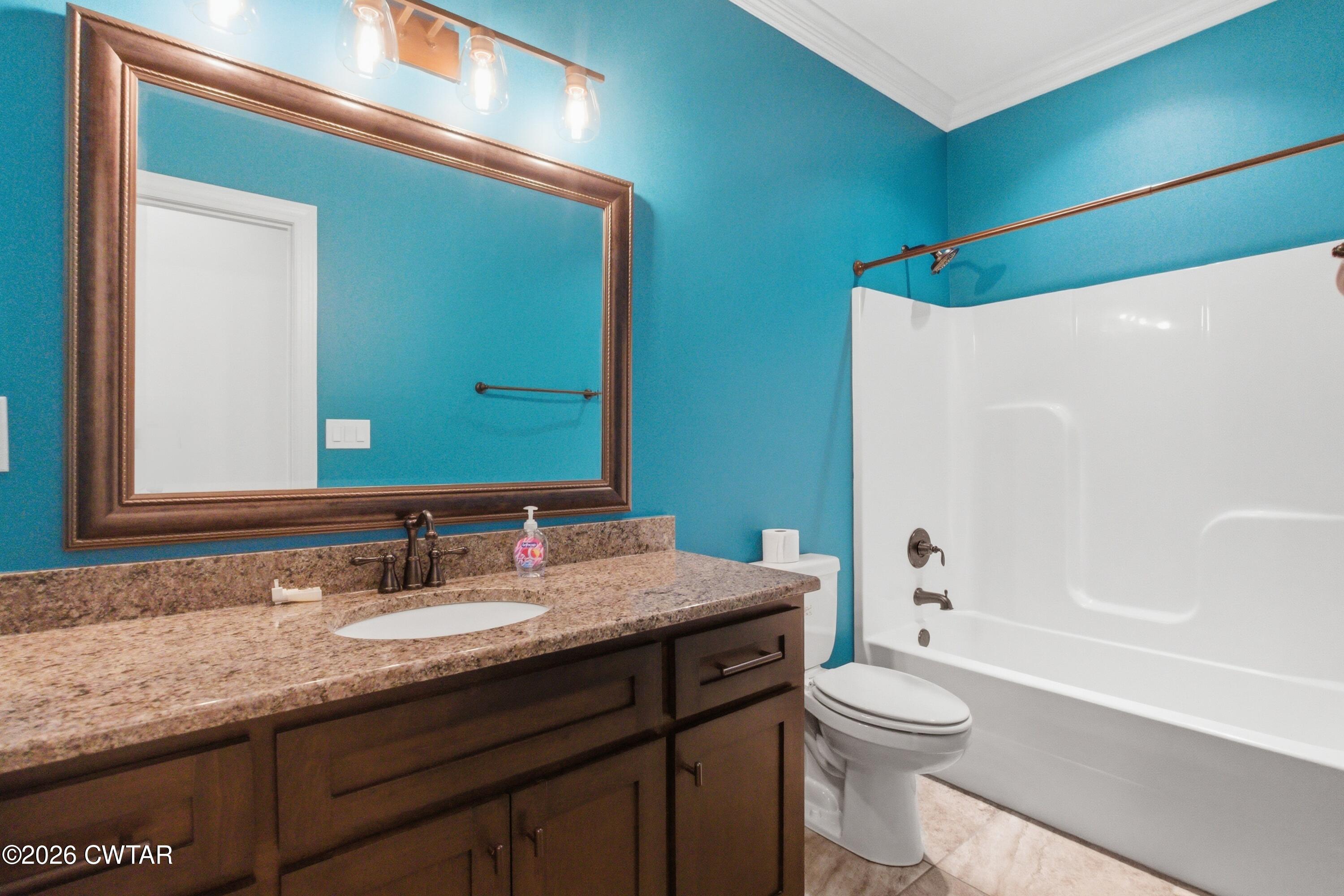 963 Ashport Road Jackson, TN 38305 - Photo 40 of 60 a bathroom with a granite countertop sink toilet and shower
