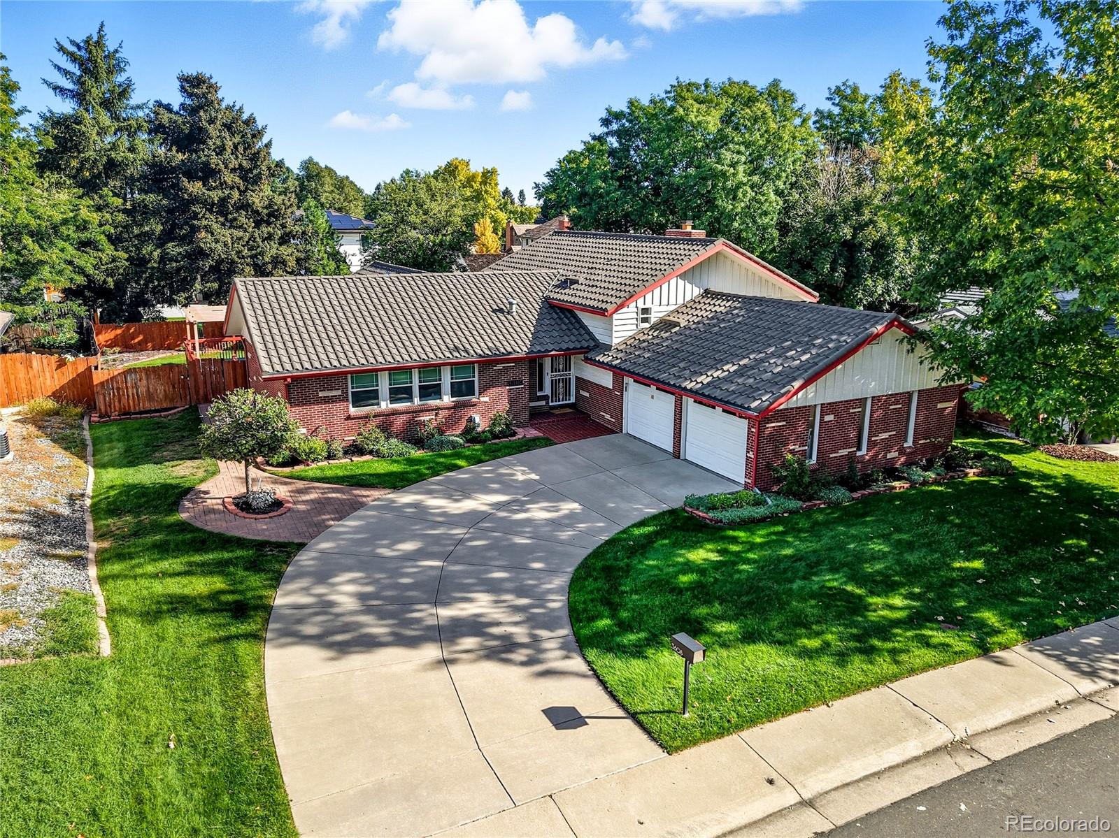 a aerial view of a house with a yard and potted plants