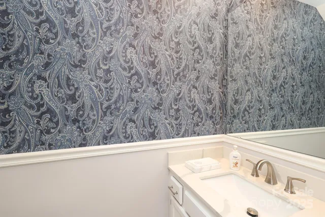 a large white kitchen with a large window