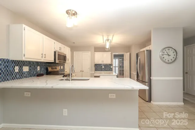 a kitchen with a sink stove and microwave