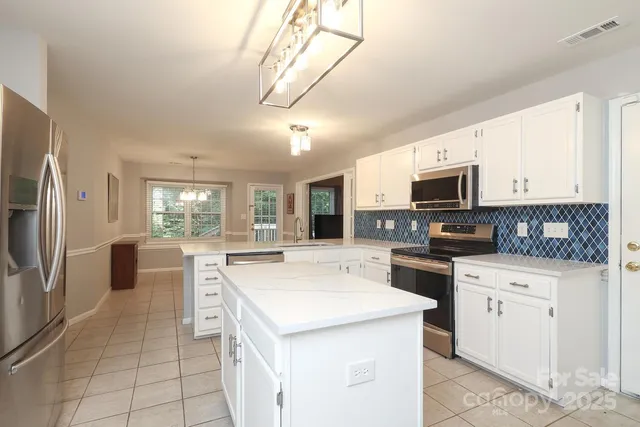 a kitchen with a stove a sink and a refrigerator