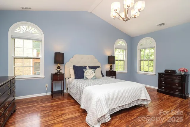 a bedroom with a bed and a chandelier