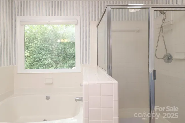 an empty room with closet and a ceiling fan