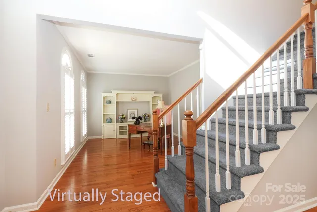 a view of entryway and hall with wooden floor