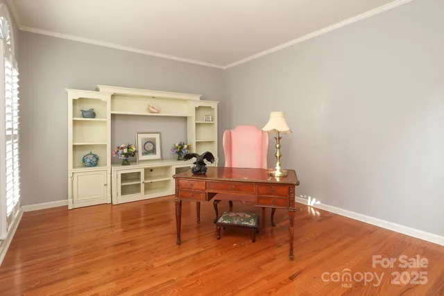 a view of a livingroom with furniture window wooden floor and a chandelier