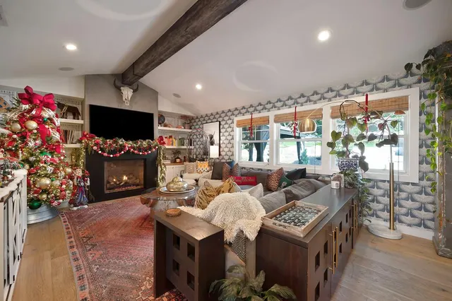 a living room with fireplace furniture and a flat screen tv