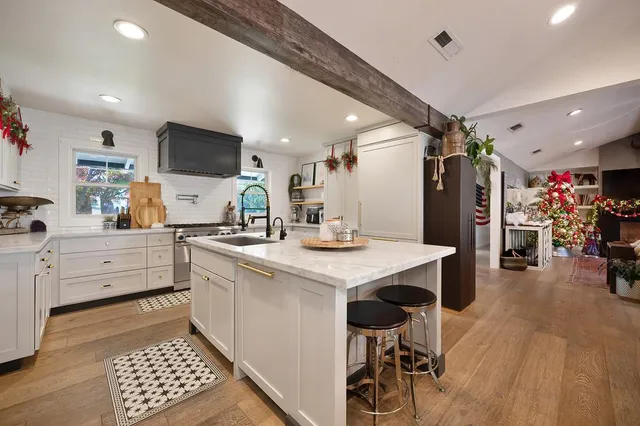 a kitchen with a sink appliances and cabinets