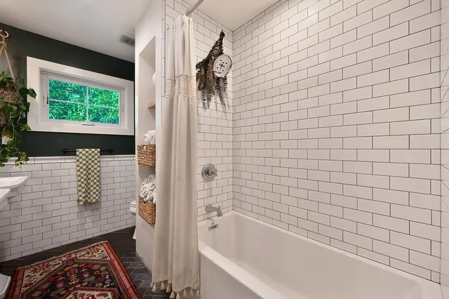 a bathroom with a bathtub and shower