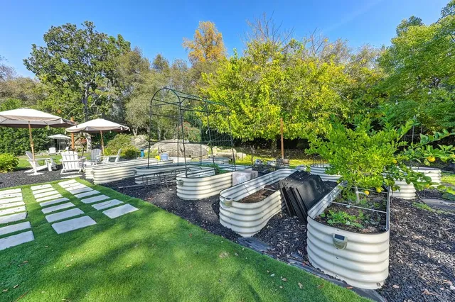 a view of a patio with chairs and an umbrella