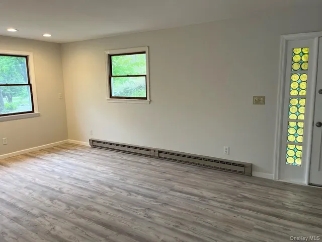 wooden floor in an empty room with a window