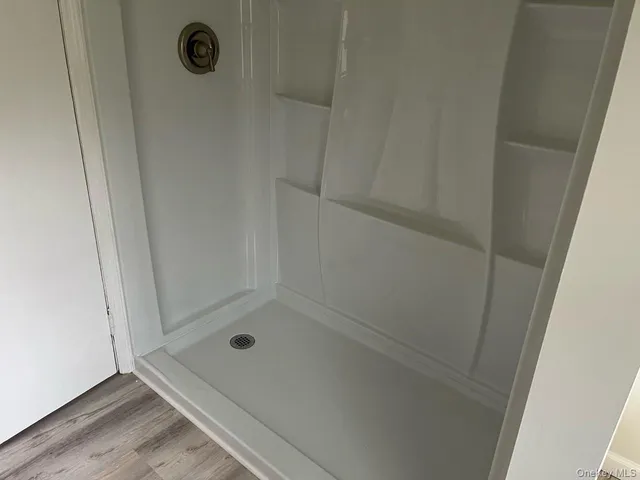 a bathroom with a glass shower door