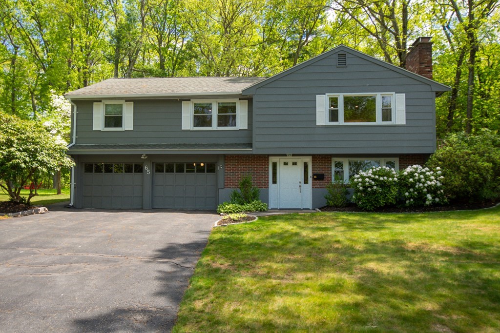 a front view of a house with yard and garage
