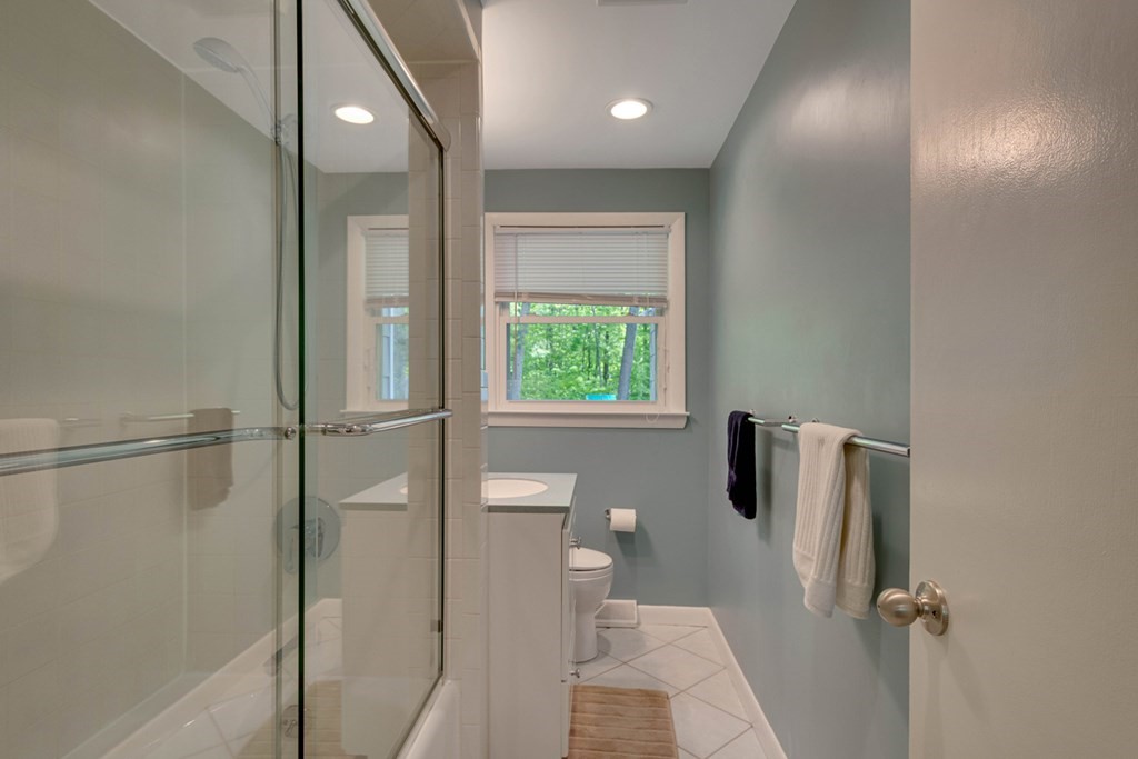 65 Angelica Drive Framingham, MA 01701 - Photo 20 of 34 a bathroom with a glass shower door