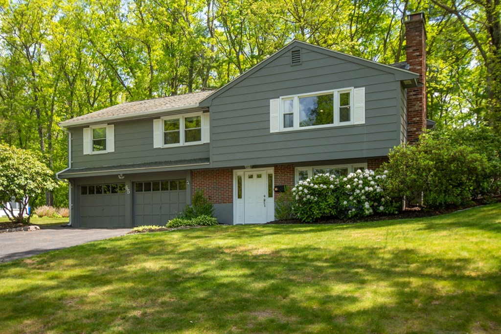 65 Angelica Drive Framingham, MA 01701 - Photo 2 of 34 a front view of a house with a garden