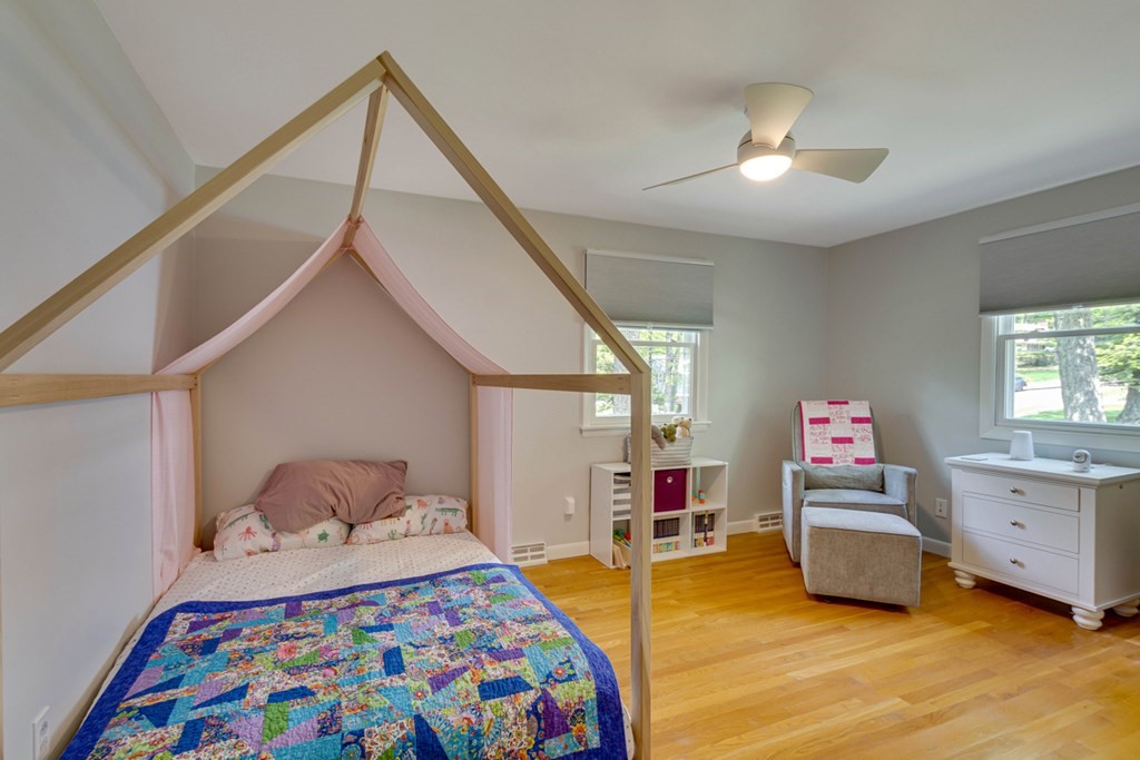 65 Angelica Drive Framingham, MA 01701 - Photo 21 of 34 a bedroom with a bed and a chandelier