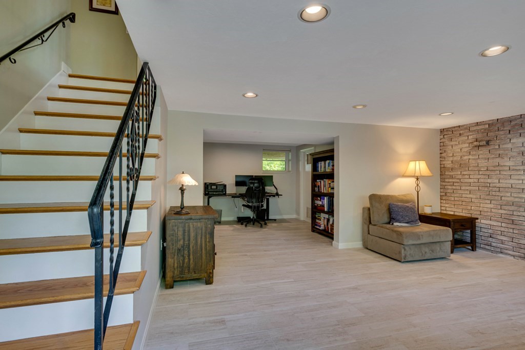 65 Angelica Drive Framingham, MA 01701 - Photo 24 of 34 a living room with furniture and a fireplace