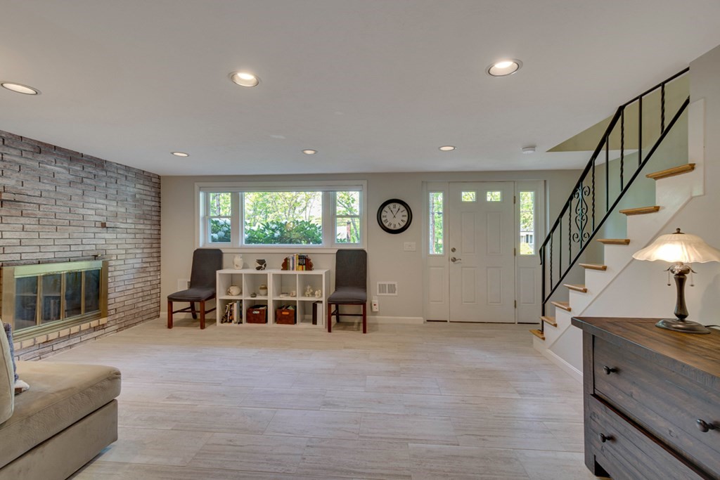 65 Angelica Drive Framingham, MA 01701 - Photo 26 of 34 a living room with furniture and a fireplace