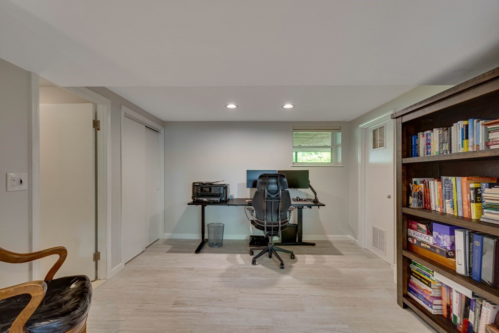 65 Angelica Drive Framingham, MA 01701 - Photo 27 of 34 a view of a workspace with furniture and a bookshelf