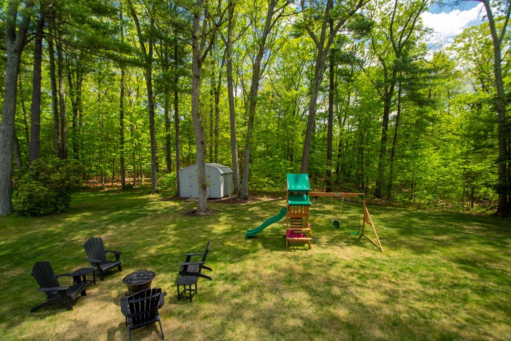 65 Angelica Drive Framingham, MA 01701 - Photo 31 of 34 a backyard of a house with table and chairs