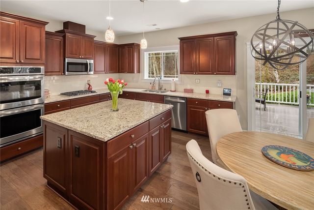 a kitchen with granite countertop counter space a sink appliances and cabinets