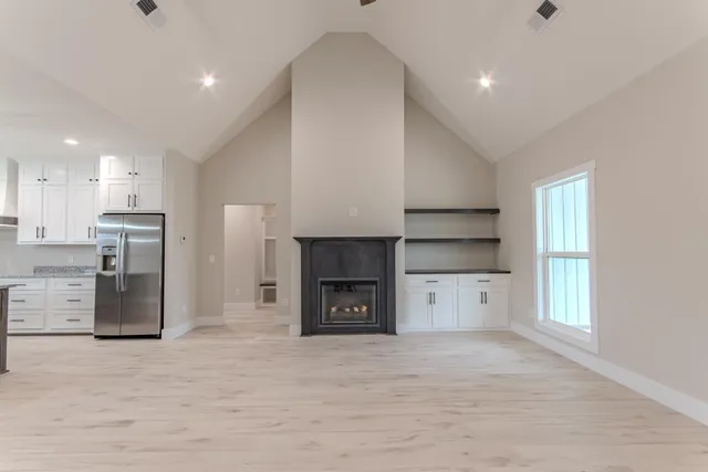 a view of a kitchen with a fridge and a window