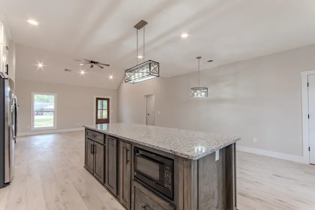 a kitchen with a stove a sink and a refrigerator
