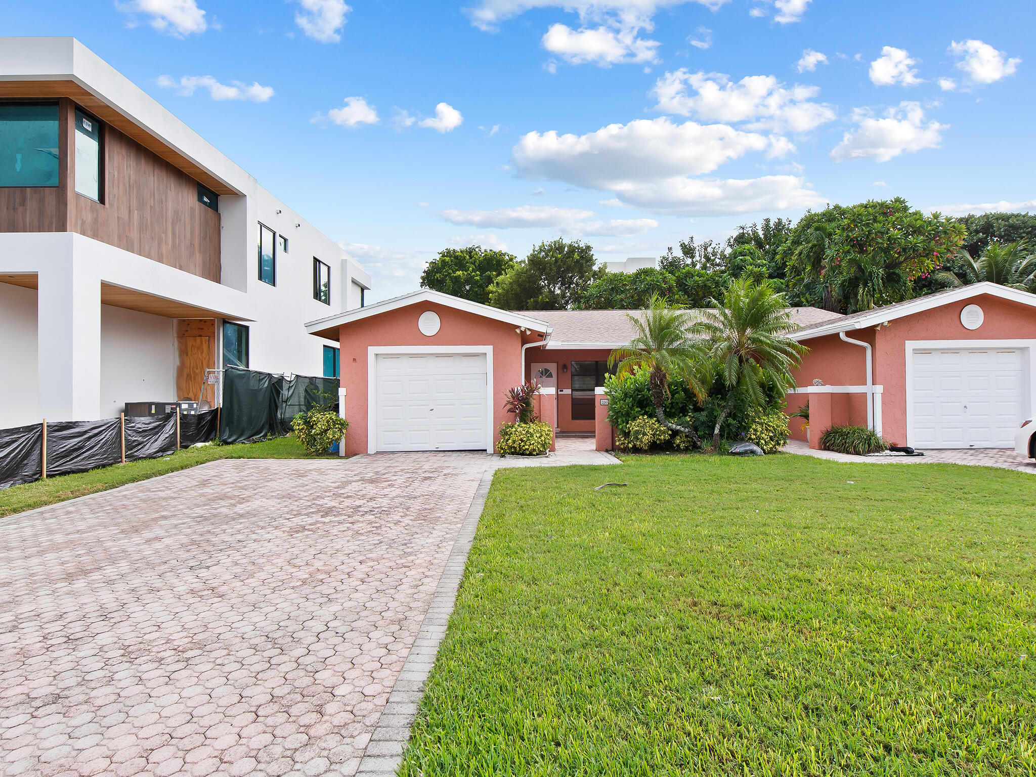 280 Northeast Wavecrest Way Boca Raton, FL 33432 - Photo 1 of 29 a front view of a house with garden