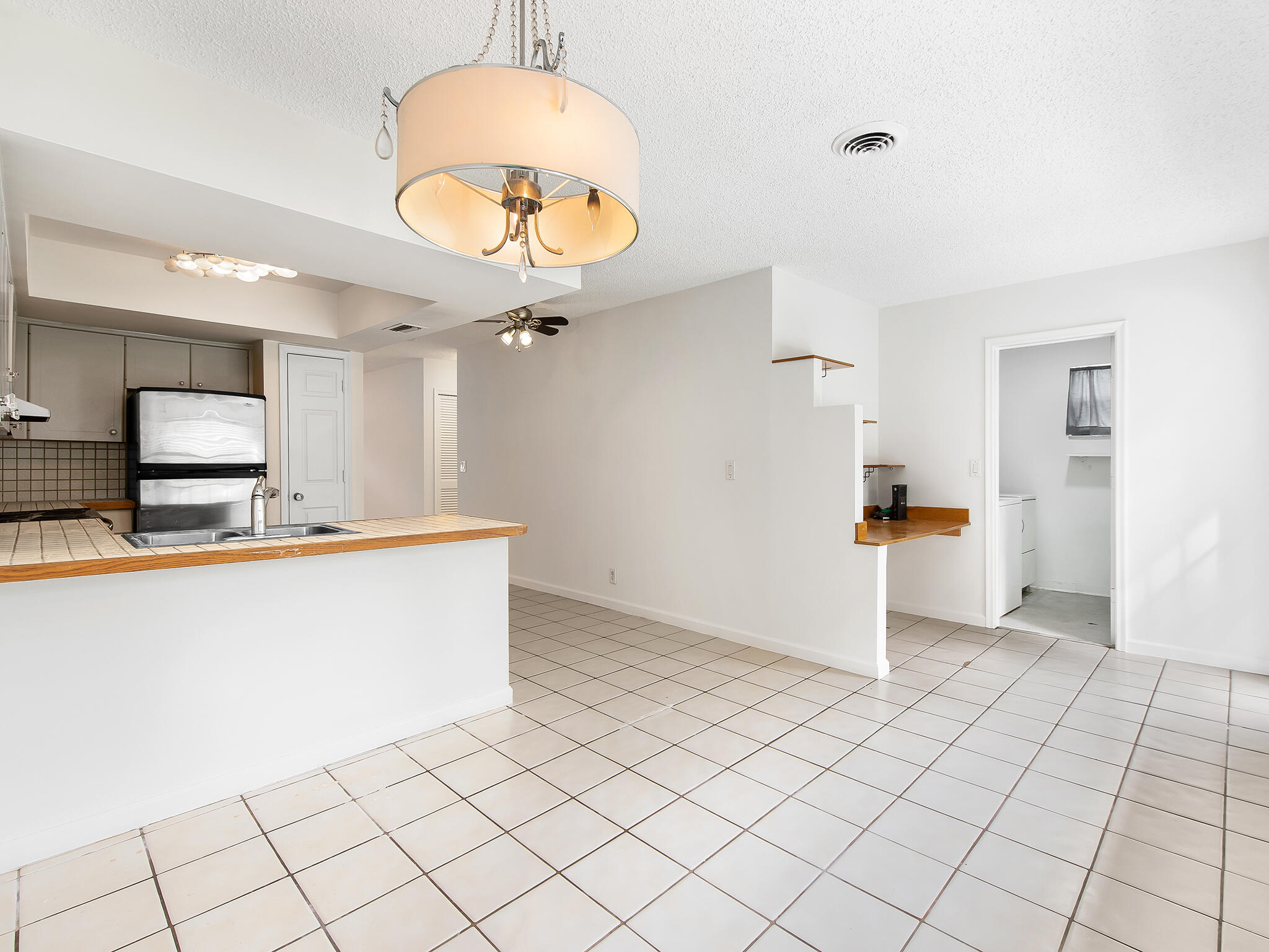 280 Northeast Wavecrest Way Boca Raton, FL 33432 - Photo 11 of 29 a large kitchen with cabinets and a wooden floor