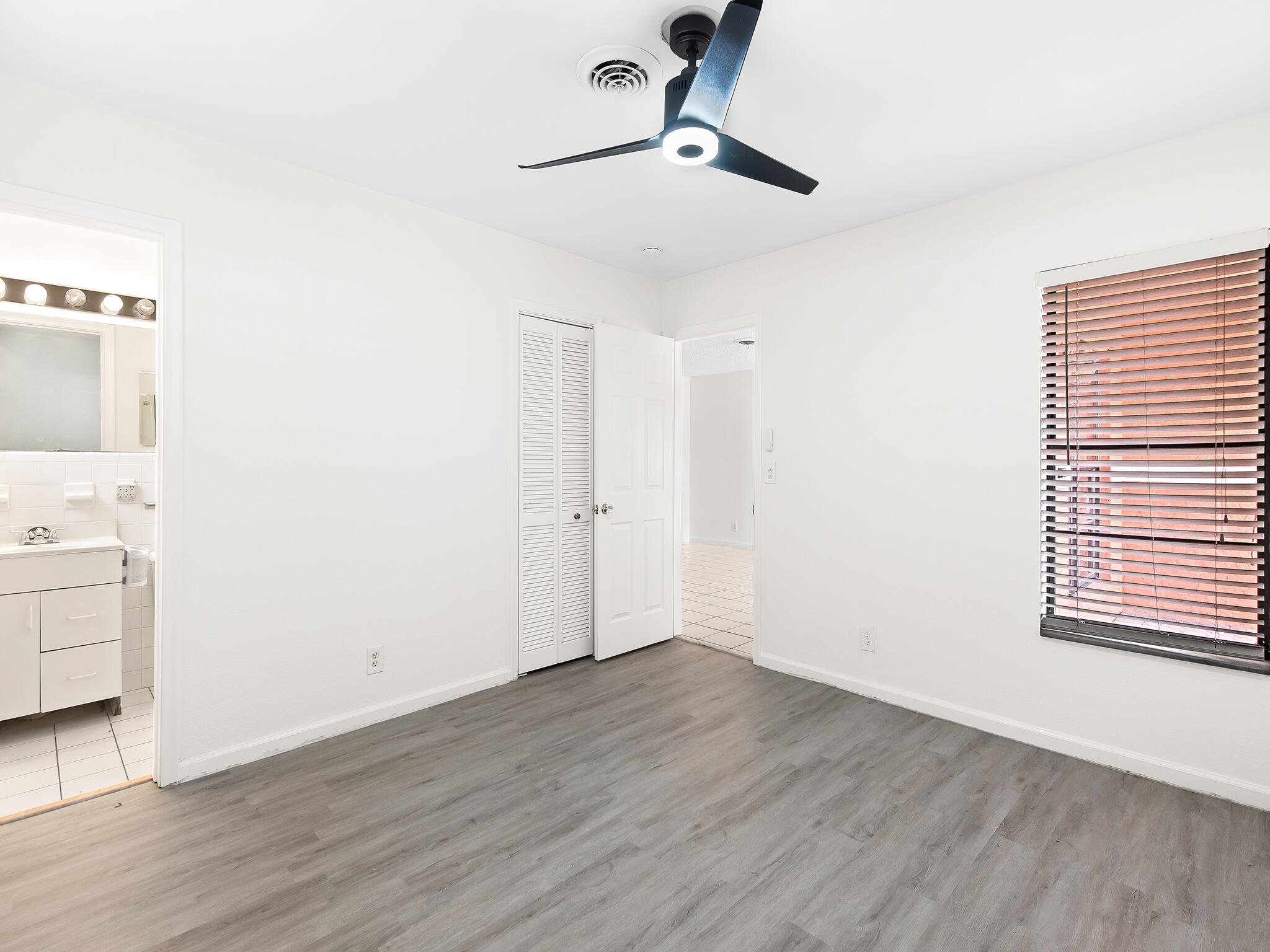 280 Northeast Wavecrest Way Boca Raton, FL 33432 - Photo 14 of 29 a view of a room with wooden floor closet and windows