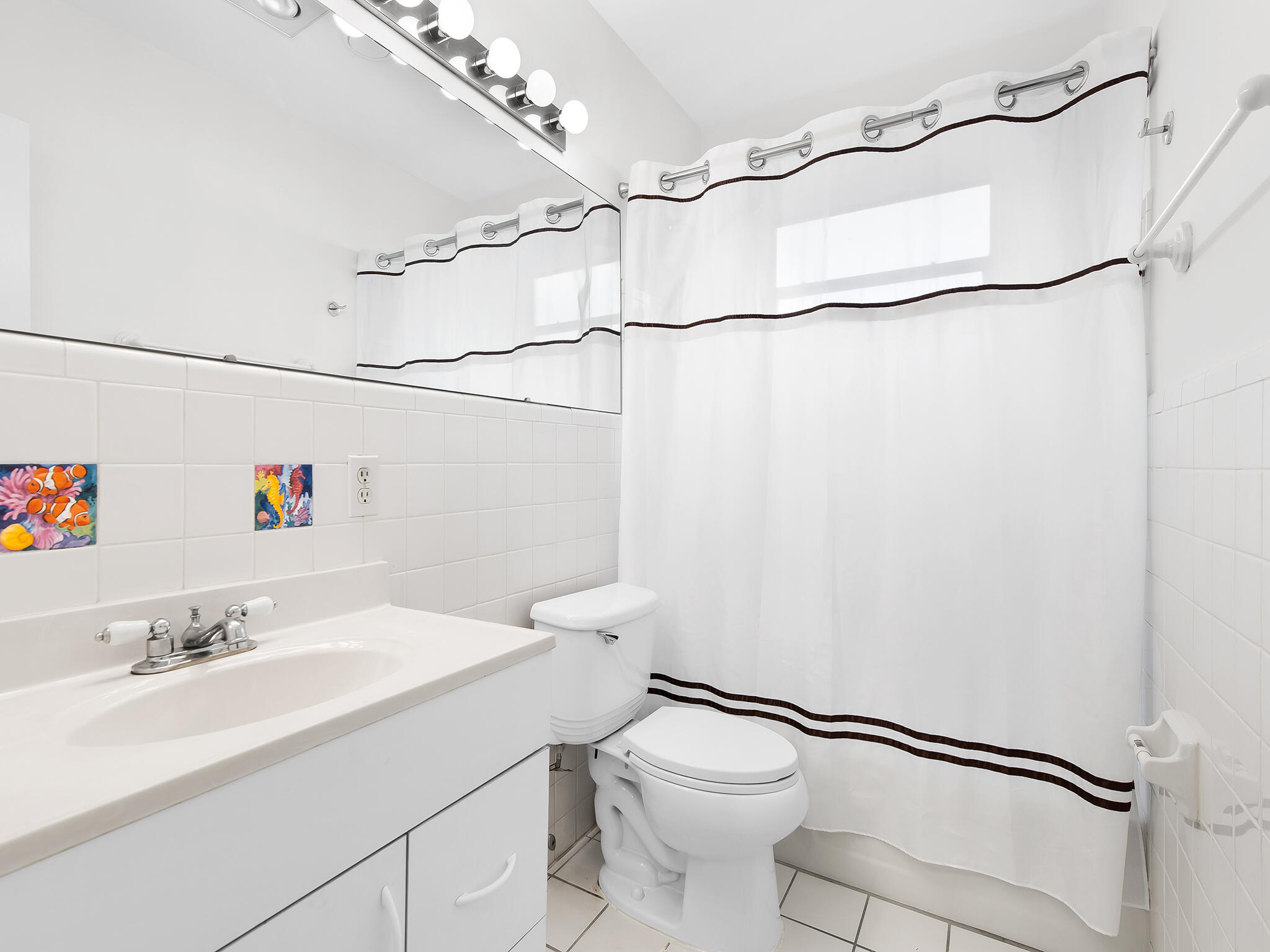 280 Northeast Wavecrest Way Boca Raton, FL 33432 - Photo 18 of 29 a bathroom with a sink mirror vanity and toilet