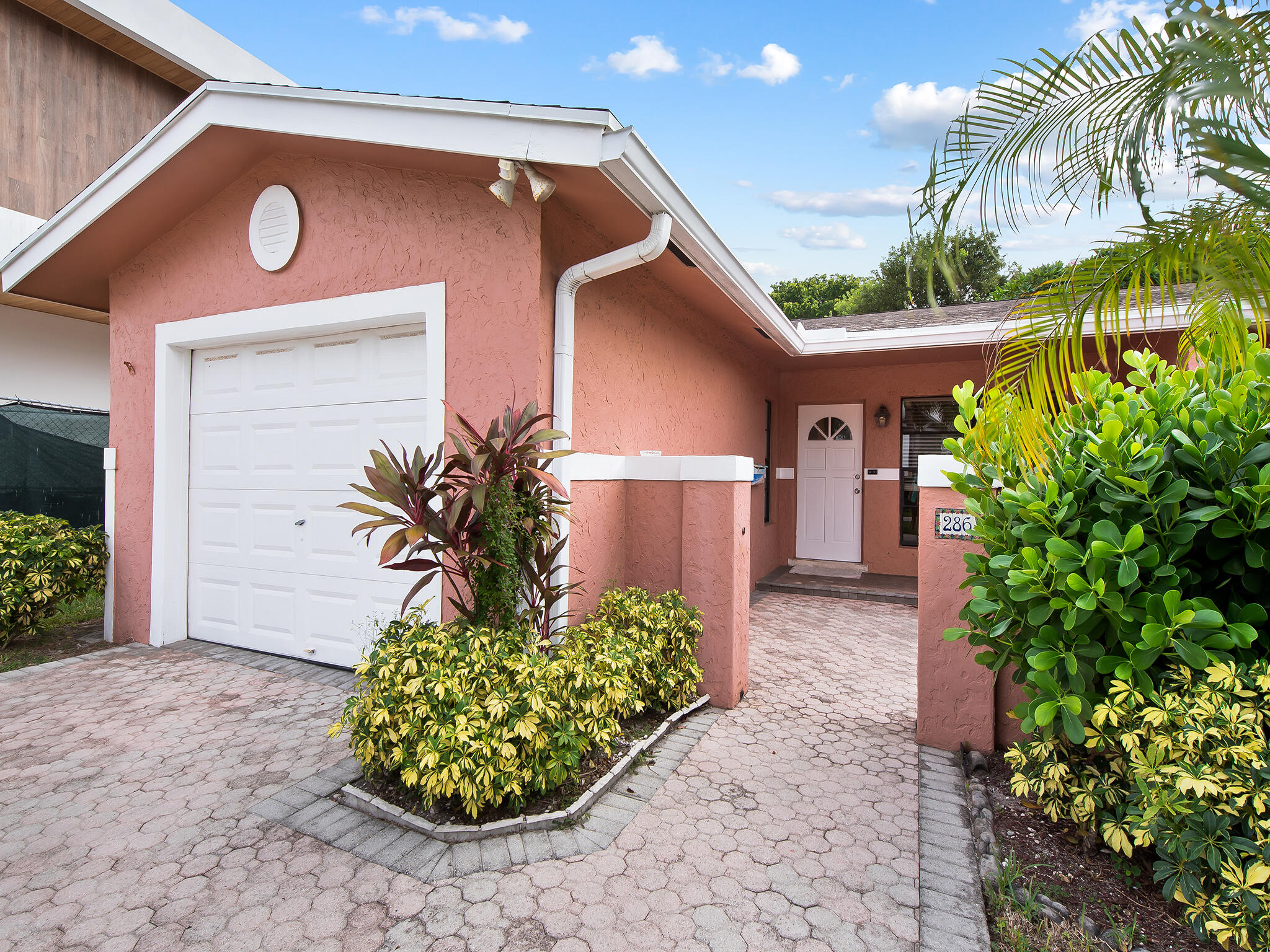 280 Northeast Wavecrest Way Boca Raton, FL 33432 - Photo 2 of 29 a front view of a house with garden