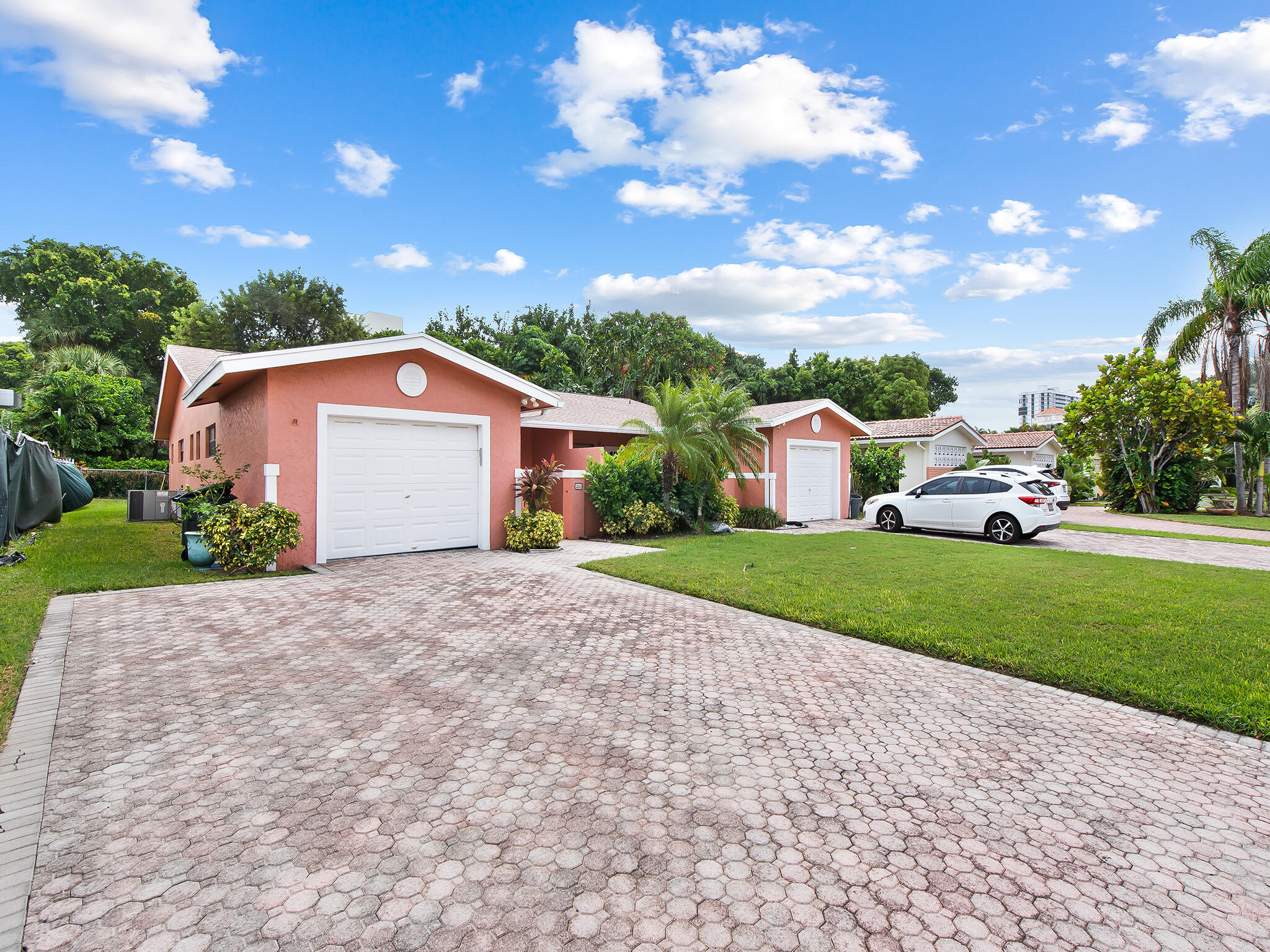 280 Northeast Wavecrest Way Boca Raton, FL 33432 - Photo 23 of 29 a yellow and red house with a garden