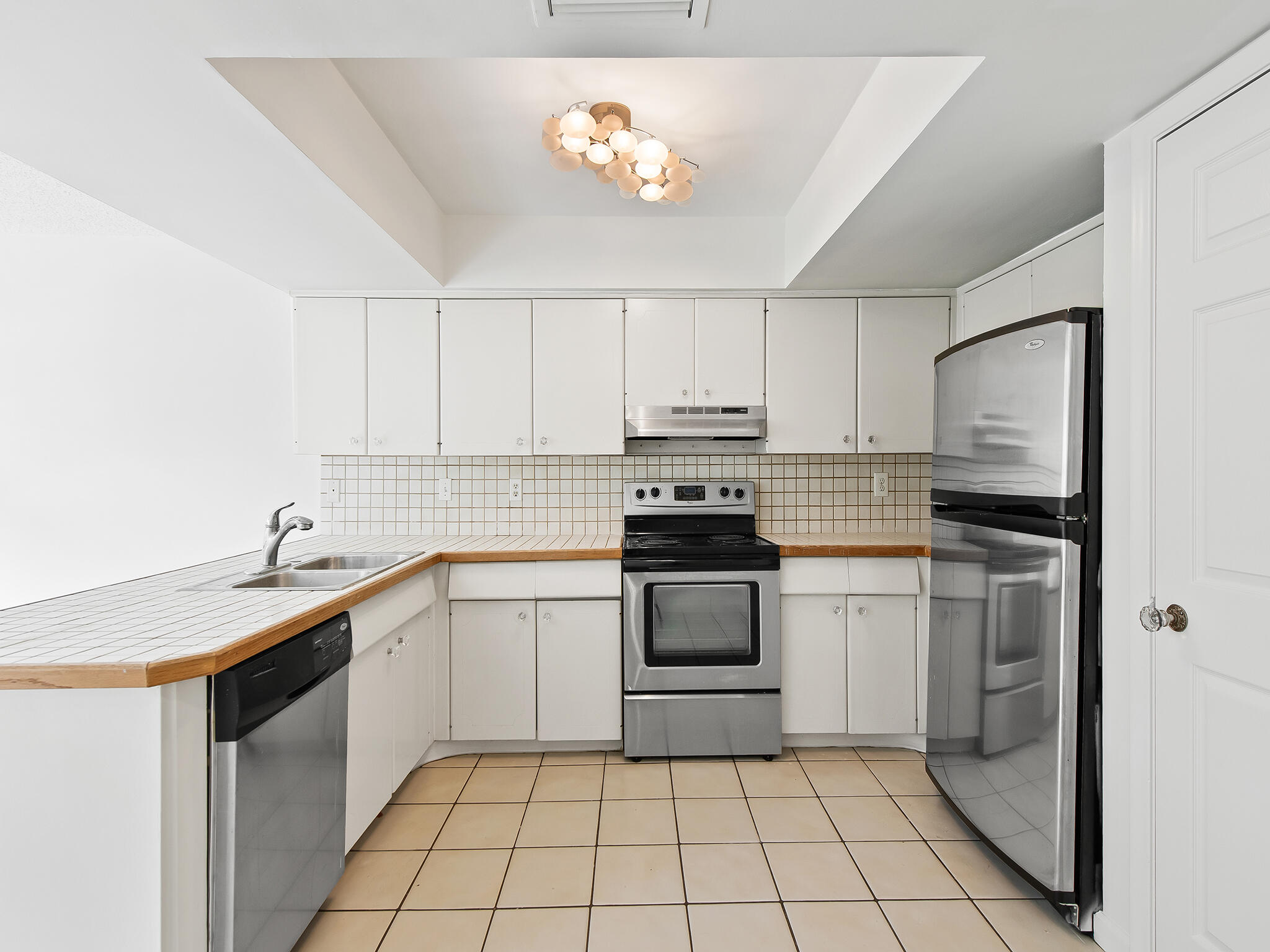 280 Northeast Wavecrest Way Boca Raton, FL 33432 - Photo 7 of 29 a kitchen with a sink appliances and cabinets