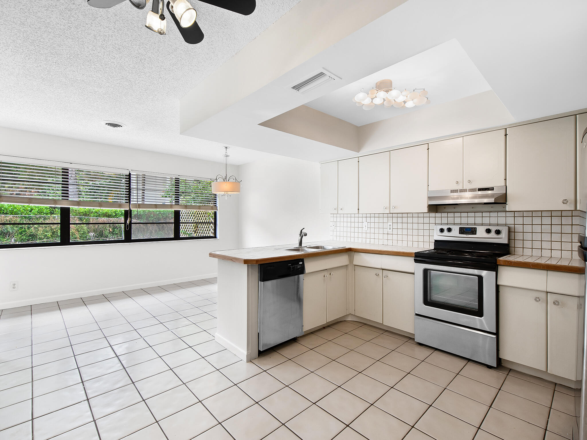 280 Northeast Wavecrest Way Boca Raton, FL 33432 - Photo 8 of 29 a kitchen with a sink cabinets and window