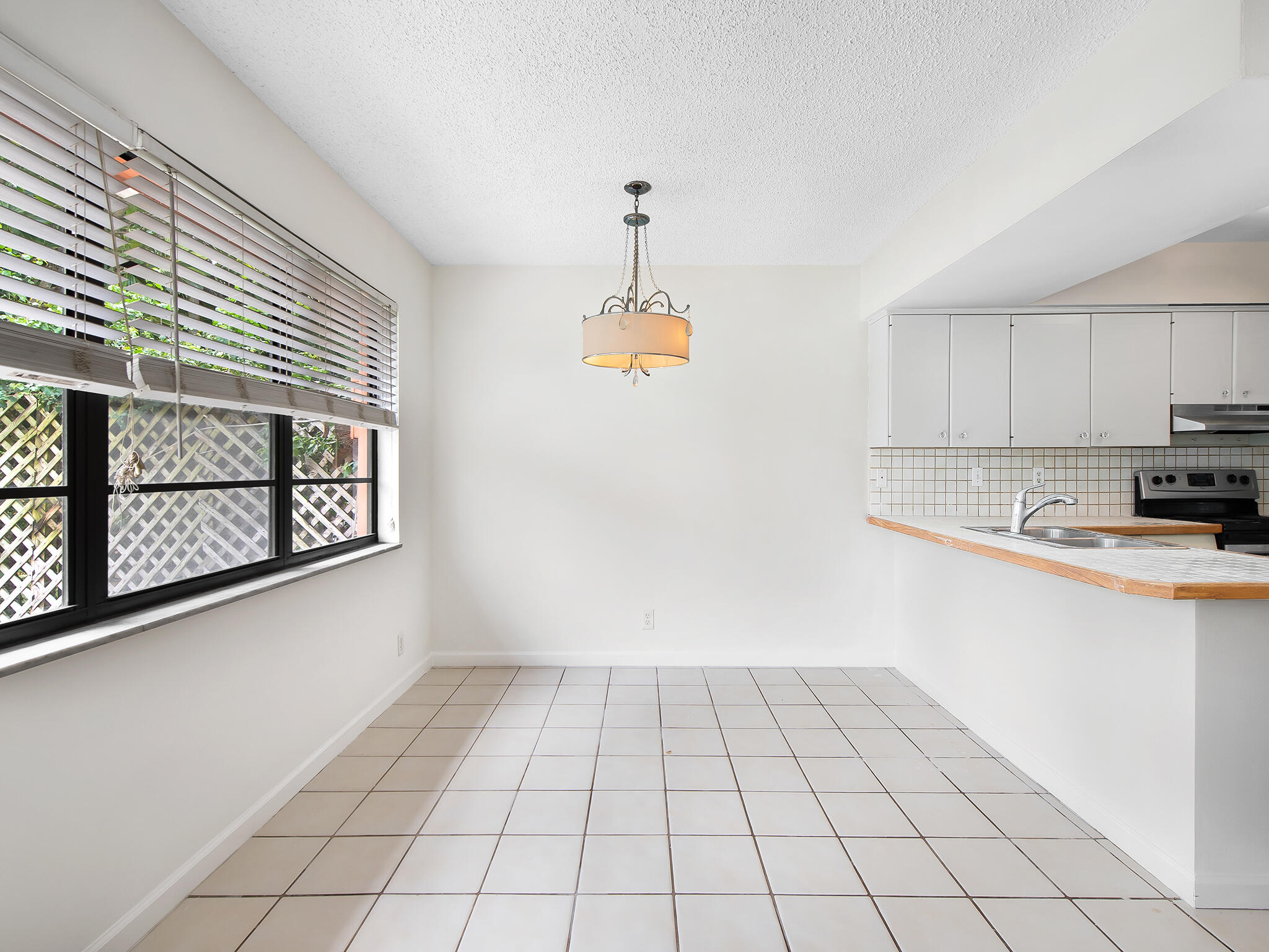 280 Northeast Wavecrest Way Boca Raton, FL 33432 - Photo 9 of 29 a kitchen with a stove a sink and cabinets
