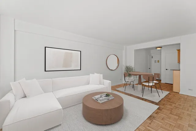 a living room with furniture a rug and a window