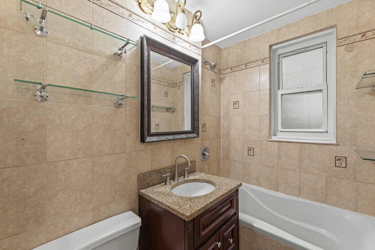 288 Lexington Avenue, Unit 3B Manhattan, NY 10016 - Photo 5 of 10 a bathroom with a granite countertop sink toilet a mirror and shower