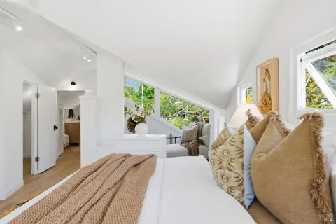 a bedroom with a bed and a potted plant